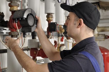 HVAC technician working on heating system