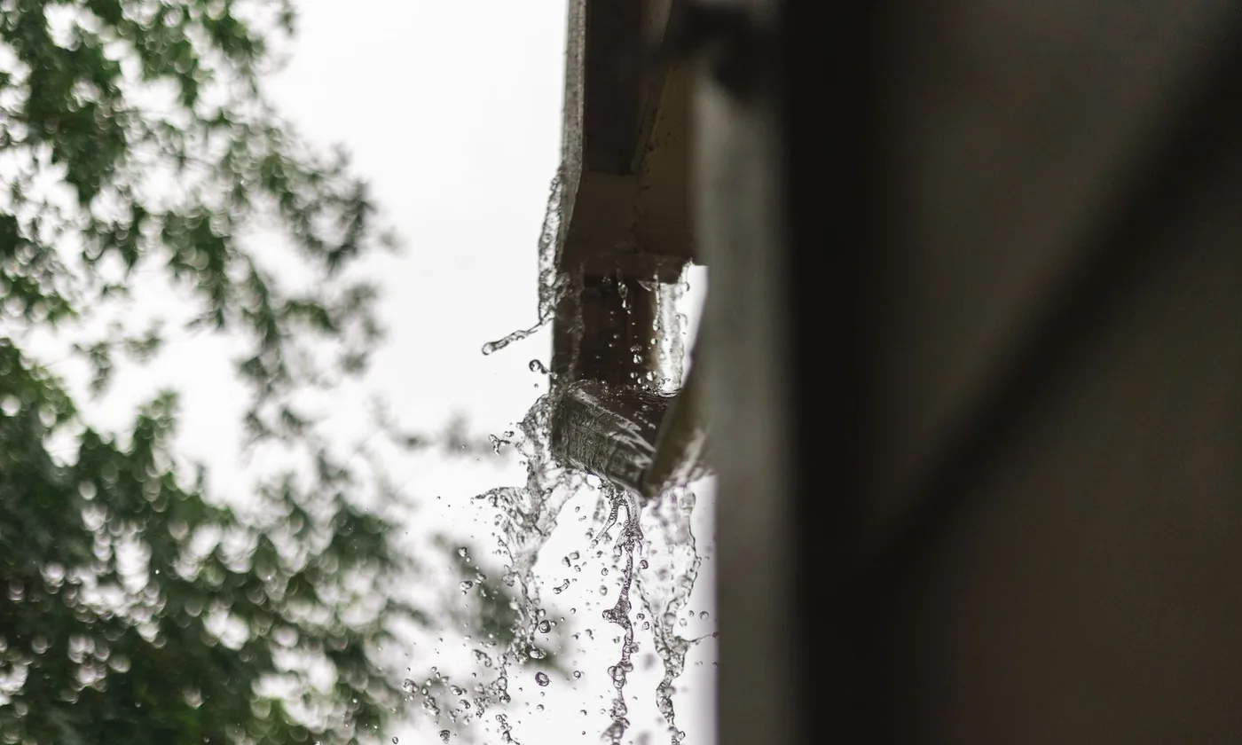 Rainwater pouring from a gutter
