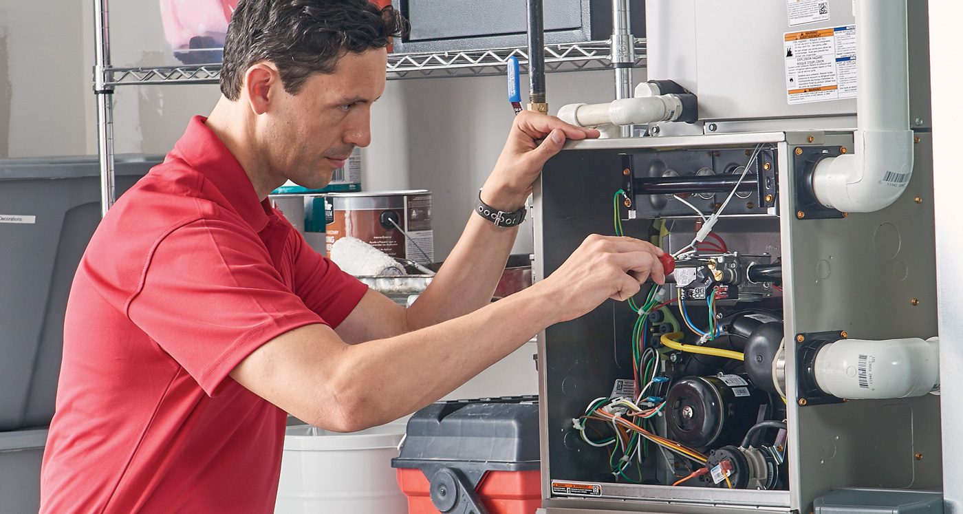 Technician servicing furnace in Vancouver