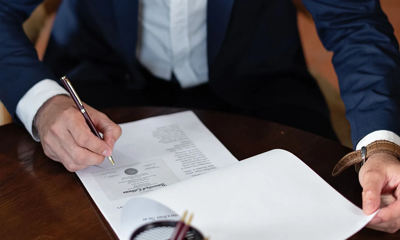 Signing home insurance paperwork at a desk
