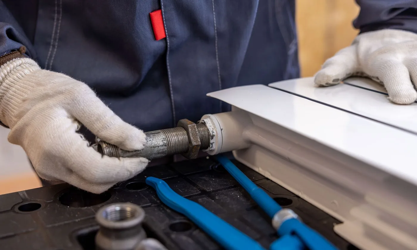 Plumber repairing a pipe in a Metro Vancouver home